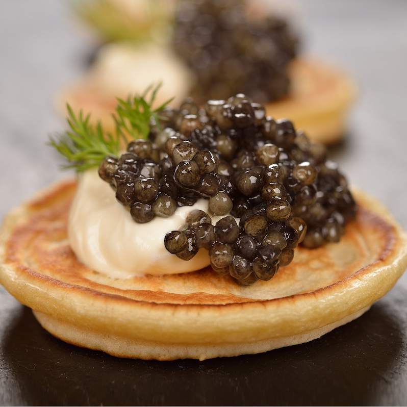 Mini pancakes with black caviar Lemberg